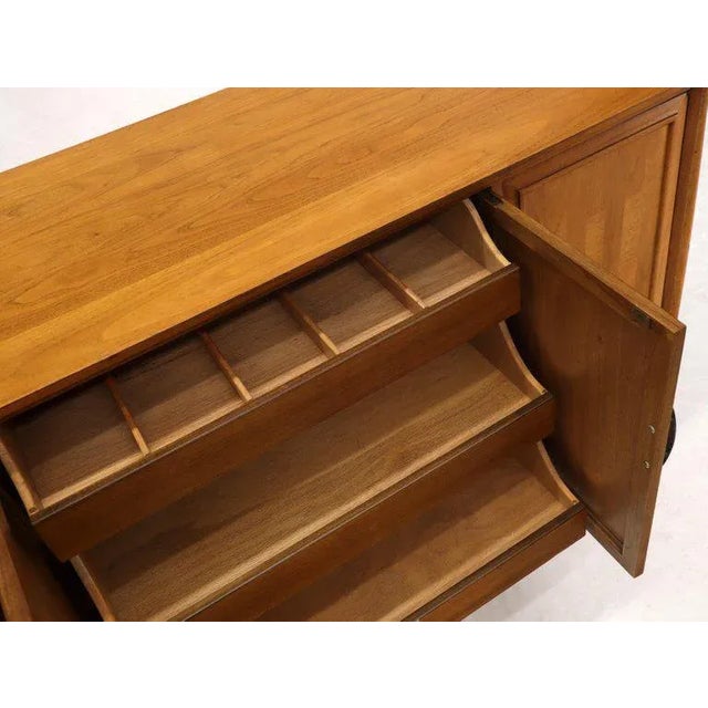 Two-door compartments with adjustable shelf’s with concealed 3-drawer compartment American light walnut midcentury dresser...