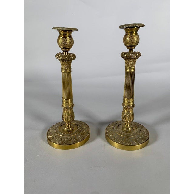 Pair of bronze candlesticks "with fruit baskets", Empire period, 19th century For Sale