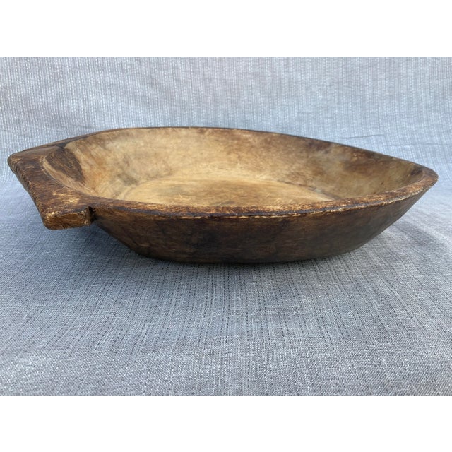 Large, antique hand hewn flat dough bowl with a large handle on one end. Lovely patina. Found on the coast of Maine. Has...