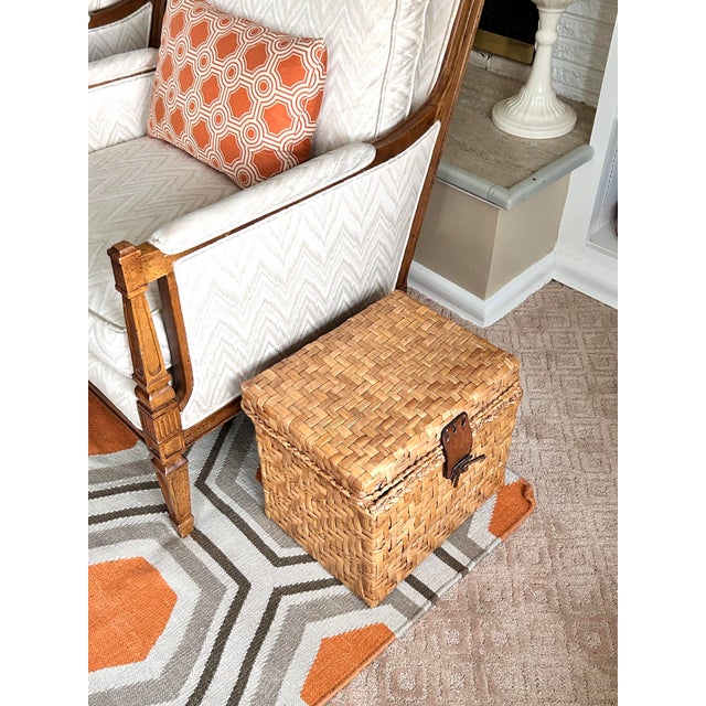 Vintage woven rattan storage box with leather closures featuring a custom designer fabric-lined interior backed with...