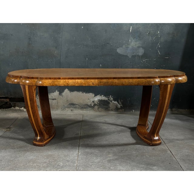 Elegant period American art deco dining table featuring a scalloped surface. Exceptional examples of burled and figured...