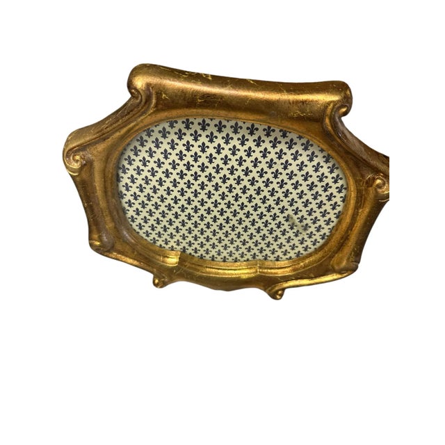 A vintage picture frame, exquisitely made in Italy and gilded in gold. The frame's intricate detailing and craftsmanship...