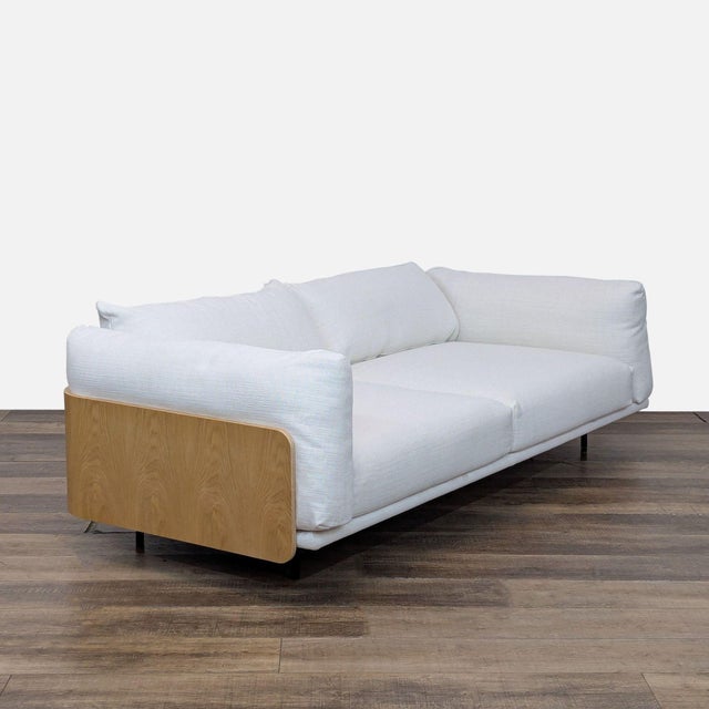 Features a wood wrap around frame with plush oversized cushions. Brand: Design Within Reach. Model: Kapsel . Original...