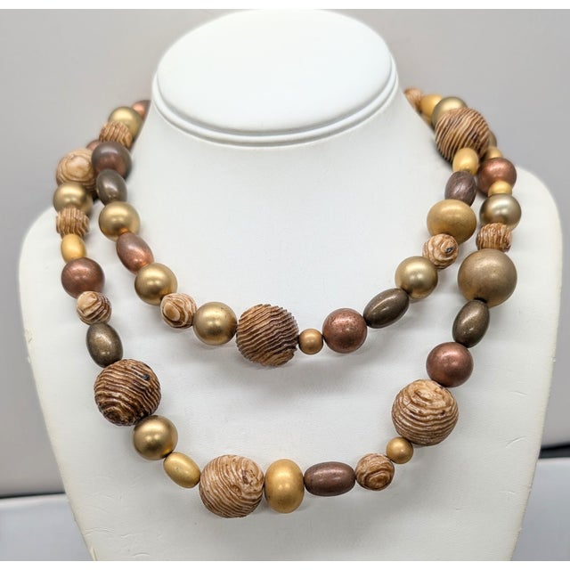 1980s matte goldtone 2-strand resin beads that look like wood with ovoid and spherical goldtone and brass beads with...