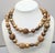 1980s matte goldtone 2-strand resin beads that look like wood with ovoid and spherical goldtone and brass beads with...