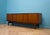 A g plan tola sideboard by e. Gomme, dating from the 1960s. It features brass handles, three drawers including a fitted...