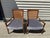 Pair of mid-century modern lounge chairs with sculpted walnut-toned frames, tapered splayed legs, and original caned...