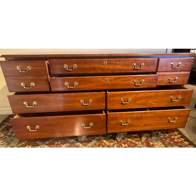 Stickley Hudson Valley Collection solid cherry triple dresser with bracket feet and solid brass bail pulls. Age: 1998....