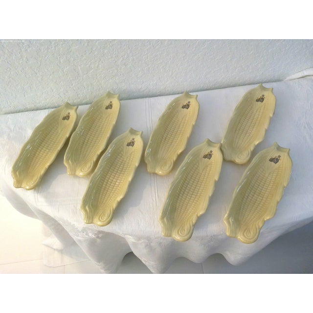 Charming set of seven deep beige ceramic corn cob dishes each featuring a delicate leaf motif in slate blue and green at...