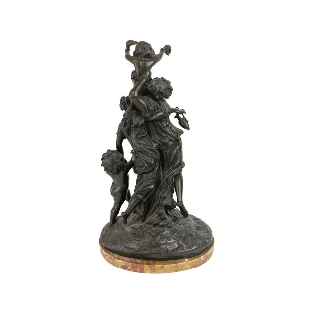 A patinated bronze group mounted on a marble base resembling the "Bacchanal" piece by Claude Michel Clodion (French,...