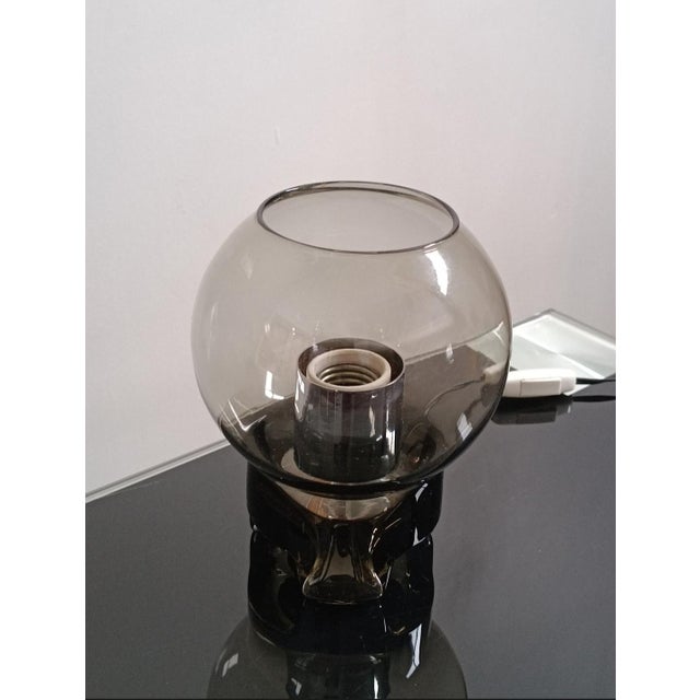 Beautiful table lamp by Sussmuth Leuchten. Germany, 1970s. All smoked clear glass, tripod base. The lamp holder is chrome-...