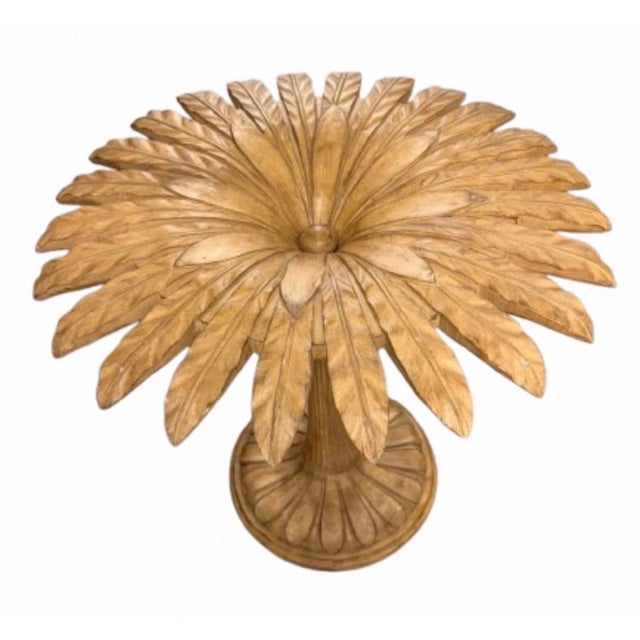 A stunning vintage Italian carved walnut dining table, featuring a clear round glass top resting on an intricately...
