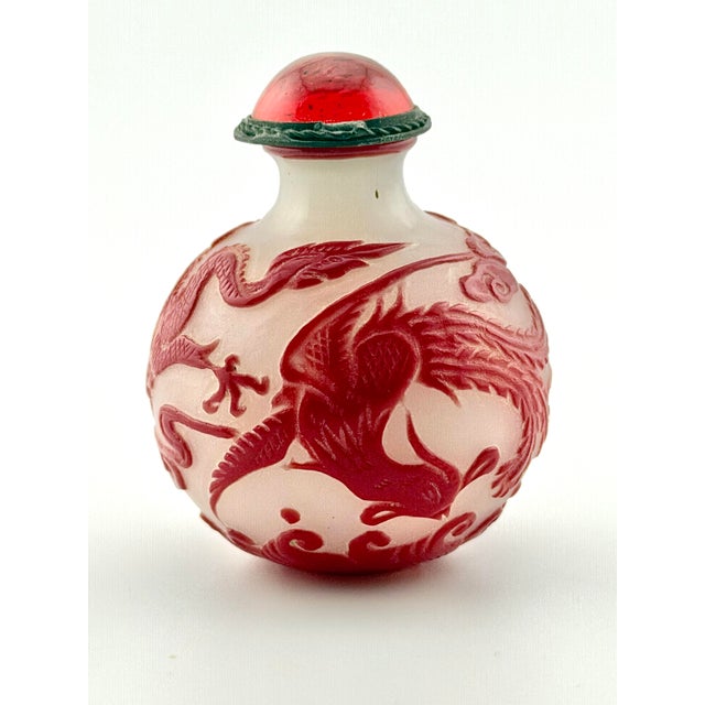An exceptional 19th-century Chinese Peking glass overlay snuff bottle, beautifully hand-carved in a classic cameo...