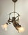 Heavy Bronze (7kgs) Chandelier of a blindfolded Cupido. The cupid hangs in a kind of branch, which is decorated with small...