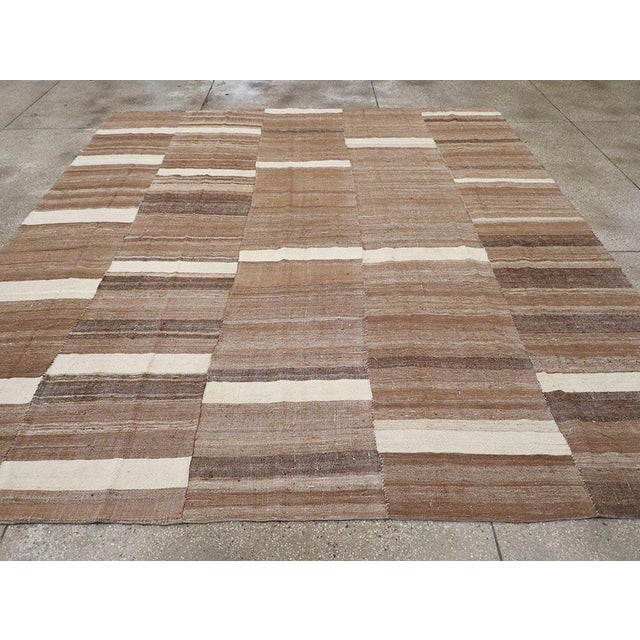 This Mid-20th century Turkish Flatweave Kilim rug, offers a striking example of traditional Anatolian textile artistry....