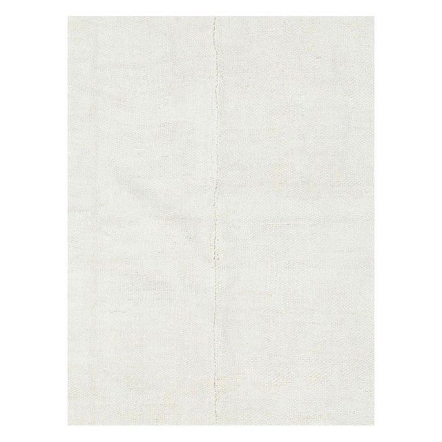 A vintage Turkish hemp flatweave Kilim small room size carpet in white handmade during the mid-20th century. Measures: 7'...
