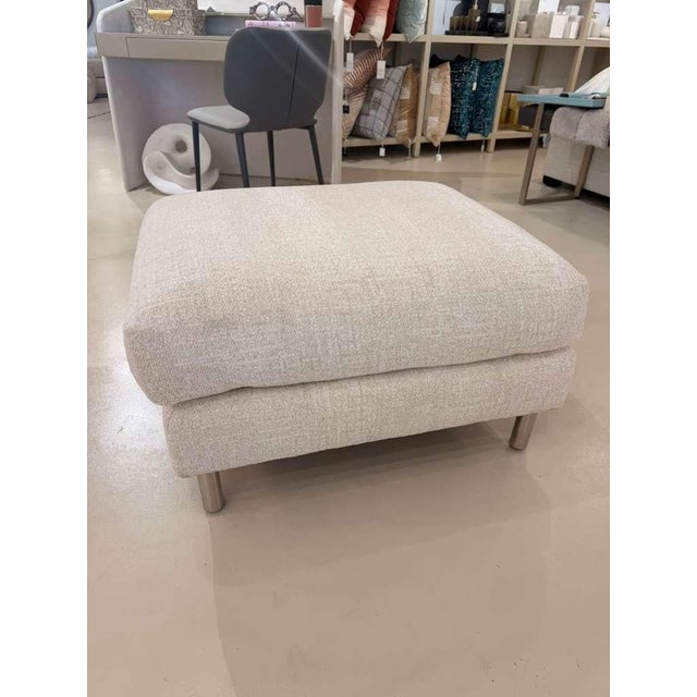 The Austin Ottoman combines sleek metal craftsmanship with tailored upholstery, creating a versatile piece that balances...