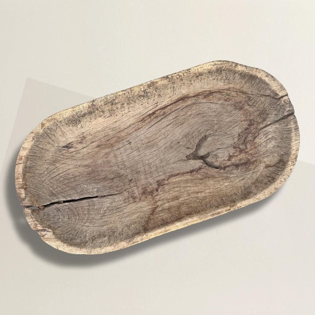 Hollowed from a single massive piece of timber, this 19th-century wooden batea was found in New Mexico, its surface...