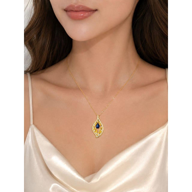 Elegant 14K pink rose gold pendant necklace featuring a natural pear-shaped sapphire weighing 1.4 carats, accented by...