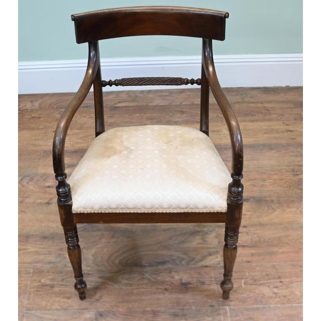 Elegant Regency style mahogany carver armchair with a broad curved top rail Decorative rope-twist cross rail beneath the...