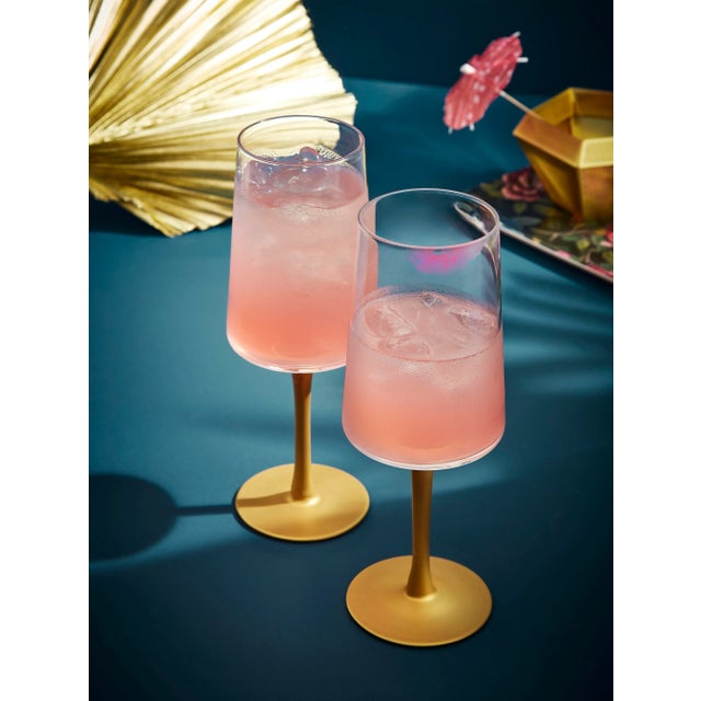 Elevate your drinkware with this set of two Gold Stem Wine Glasses from the Creatures of Curiosity collection. Perfect for...