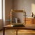 A distinctive vintage flower stand featuring a sculptural tubular steel frame with multiple colorful circular shelves...