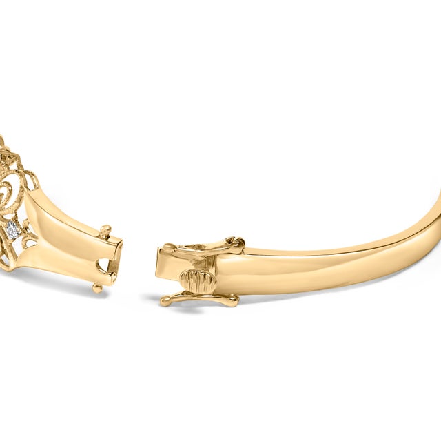 Embrace timeless elegance with this 14K gold bangle, exquisitely adorned with radiant natural diamonds totaling 1.00...