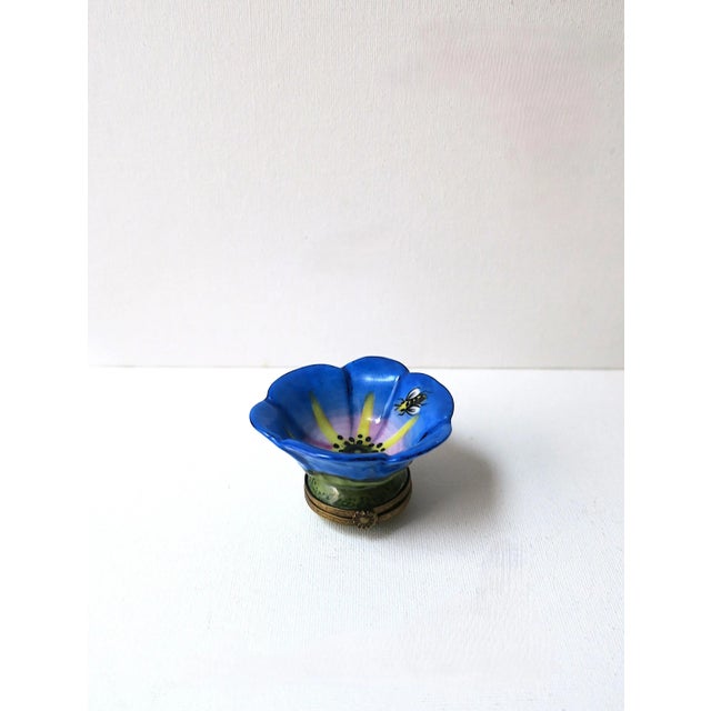 A beautiful French porcelain jewelry dish and pill box, with flower and bee design, circa late-20th century, France. Hold...