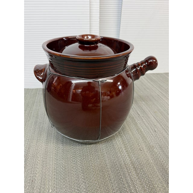Design Plus Gallery presents a Vintage Chinese Brown Glazed Stoneware Herbal Medicine Pot. This traditional ceramic vessel...