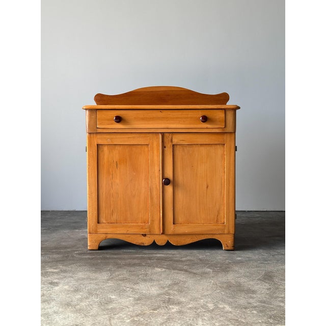 A country pine dry sink with a shaped gallery back rising above a single drawer and two-door cabinet base - a simple,...