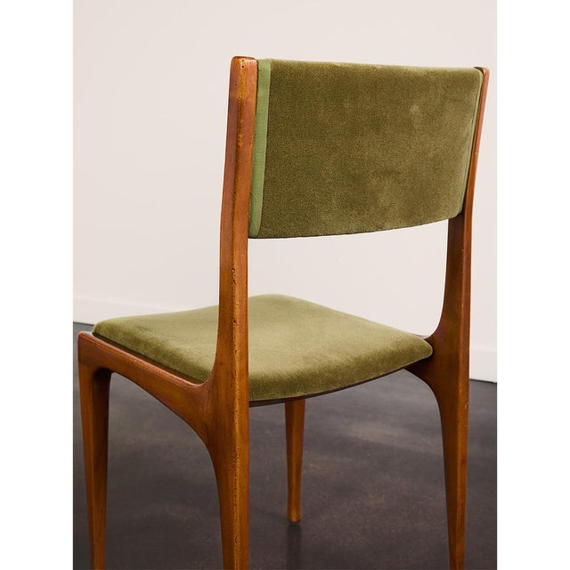 A set of six Italian dining chairs by Carlo De Carli for Cassina, model 693, introduced in 1958. The chairs feature solid...