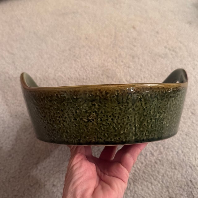 A charming vintage mid-century ceramic vegetable serving dish, featuring a rich avocado green majolica-style glaze. The...