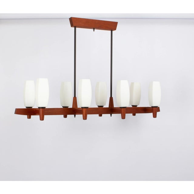A wonderful midcentury teak chandelier. A unique, timeless and elegant masterpiece of danish teak wood designed by kaiser...