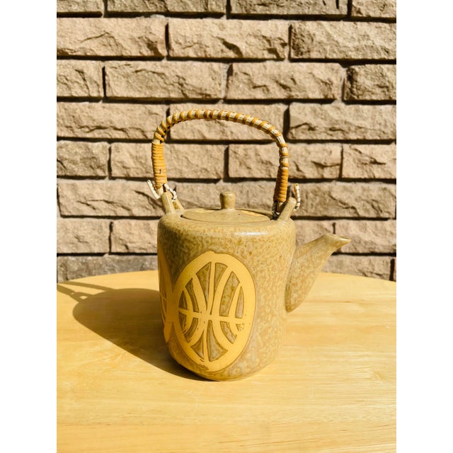 Beautiful yet simple mid century Japanese ceramic teapot. Light pattern design and green oven reed handle. Removable lid,...