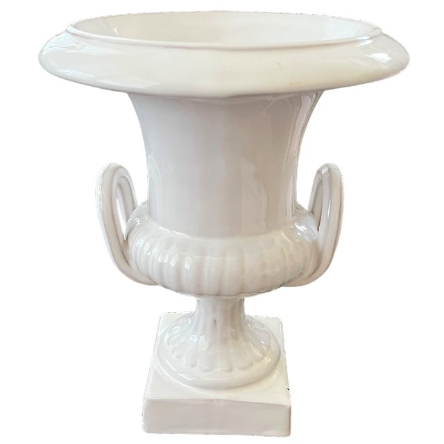 A handsome mid-20th century Italian ceramic urn in glossy white glaze. Inspired by classical antiquity, the vase features...