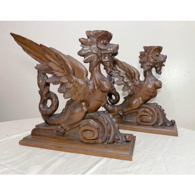 Up for sale is an exquisite pair of antique 19th century hand carved wooden winged griffin sculptures. These large salvage...