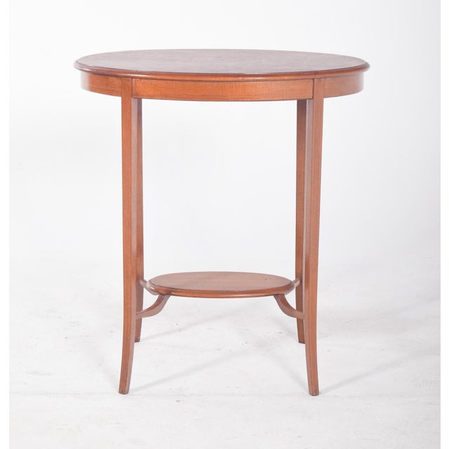 Oval coffee table with curved legs. with elegant lines and balanced proportions. It rests on four slender, slightly curved...