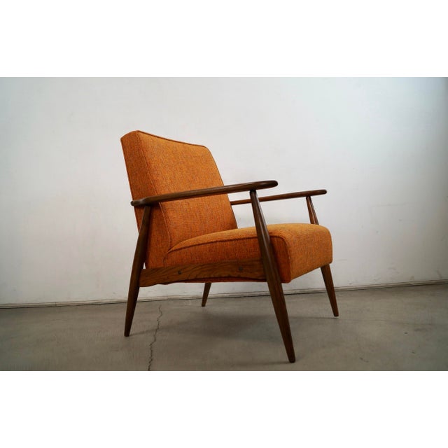Vintage original Midcentury Modern lounge chair for sale. It has been professionally refinished and reupholstered in new...