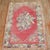 An early 20th-century floral motif Turkish Ghiordes rug in pink. 3'11'' x 5'11''