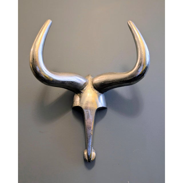 Traveling Man Treasures is selling this vintage 1980s polished aluminum Longhorn Steer minimalist sculptural wall art...