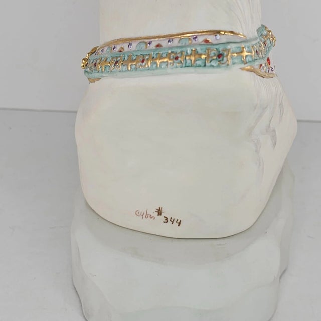 This exquisite Cybis horse head bust features intricate floral accents and jewel details, showcasing fine craftsmanship in...