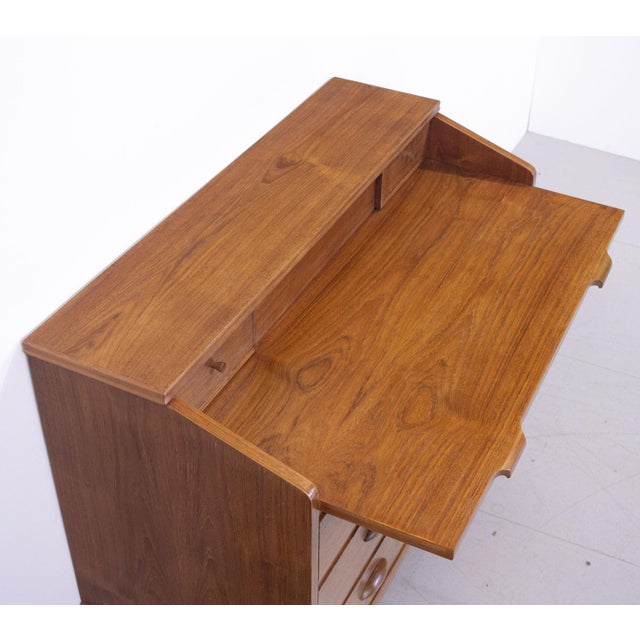 1960s Danish teak bureau designed by Borge Hansen for Riis Antonsen. The bureau has 3 large and 2 small drawers with a...
