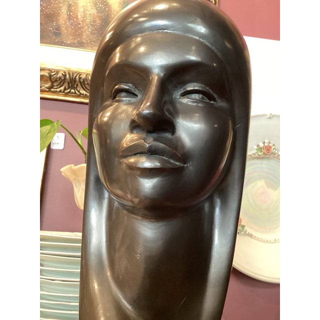 This is a mid-century hand-carved wooden sculpture signed “Arias,” and attributed to the Bolivian artist G. Arias, dating...