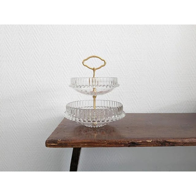 This two-tiered cake stand from Walther Glas from the Fabiola series is a timeless offering bowl from the 1970s. The round...
