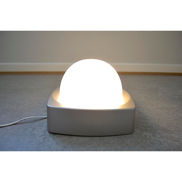 A 1970s wall or ceiling light from the dutch lighting company herda. The light is made of orange hard plastic, possibly...