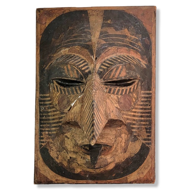 This unique vintage sculpture is a hand-crafted tribal bird mask made of paper mache. The mask is mounted on a wooden...