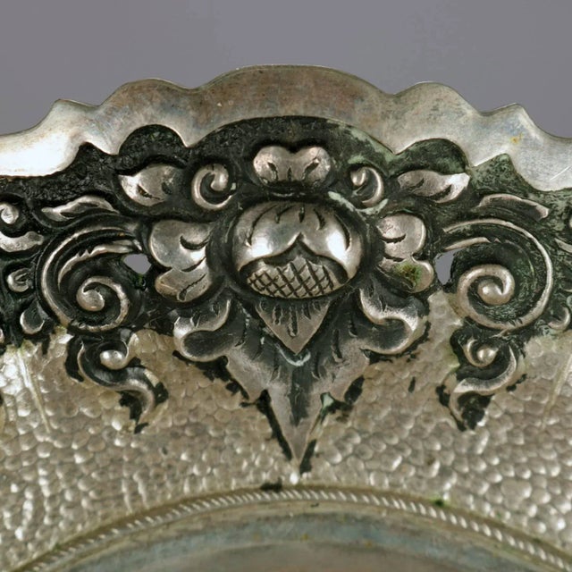 Continental .800 silver bride's basket features reticulated floral and scroll repousse border, swivel handle, en verso and...