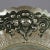 Continental .800 silver bride's basket features reticulated floral and scroll repousse border, swivel handle, en verso and...