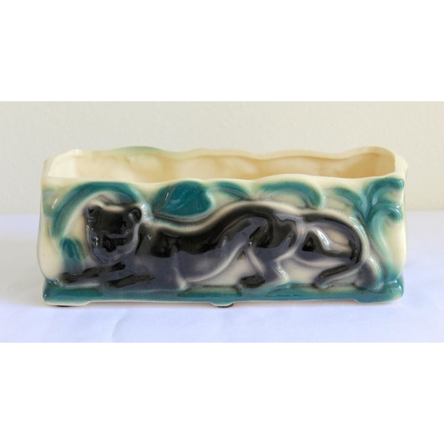 Bring iconic 1950s Mid-Century Modern style into your home with this exceptional vintage ceramic black panther console...
