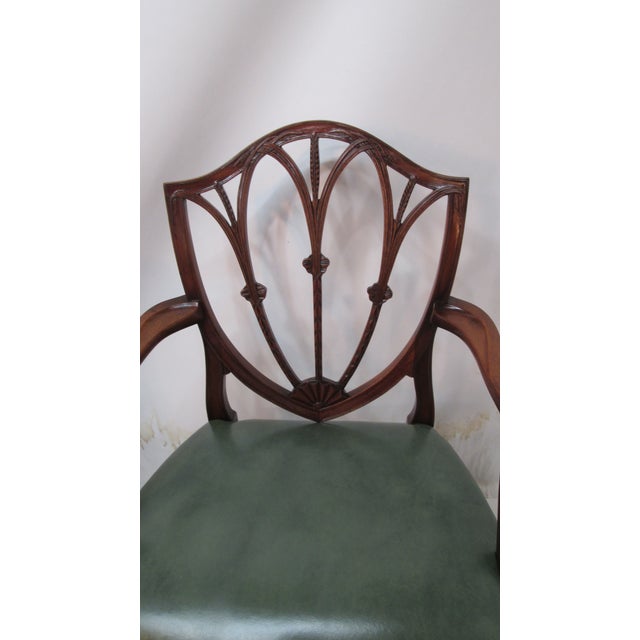 This is a set of 8 vintage shield-back mahogany dining chairs. They are Hepplewhite style. They have a leather seats ....